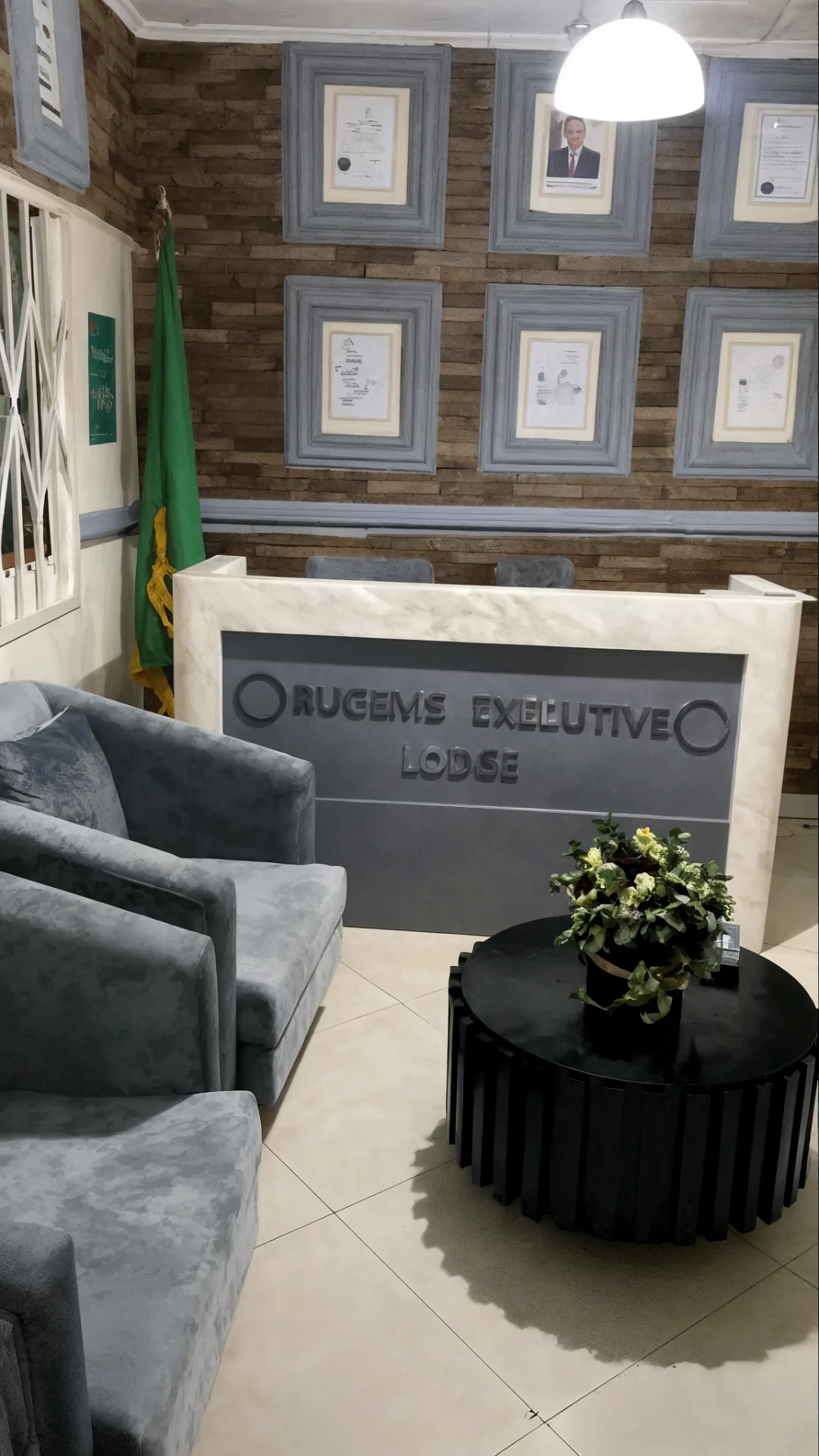 Rugems Executive Lodge reception lobby with plush seating and branded desk